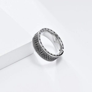 Close-up of vintage Viking runes and Celtic knot pattern on silver stainless steel ring