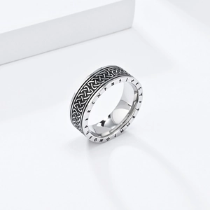 Macro detail of Nordic rune engravings and black Celtic knots on silver stainless steel ring
