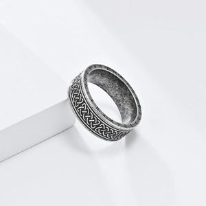 Detailed macro view of Celtic knot pattern and Nordic runes on a vintage steel ring