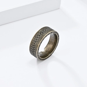 Close-up of vintage Celtic knot pattern and Nordic runes on a stainless steel ring
