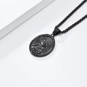 Macro detail of black Saint Michael shield pendant with woven wheat chain necklace