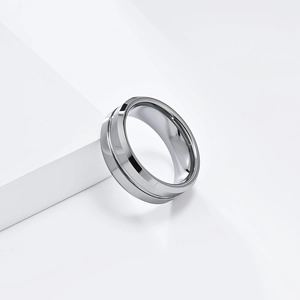 Detail of 8mm minimalist tungsten steel ring with a center groove on a white pedestal