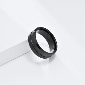 Close-up of 8mm polished black tungsten ring featuring a sleek geometric center groove