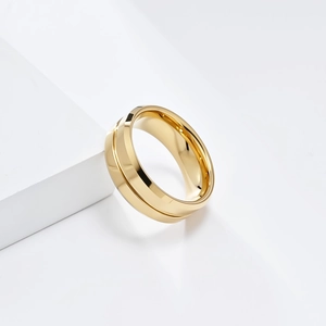 Macro detail of polished 8mm tungsten ring with high-gloss mirror finish and golden groove