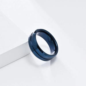 Macro view of polished deep blue tungsten ring showing the high-gloss surface and center groove