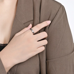 Close-up of matte brushed tungsten steel ring worn by model with professional styling