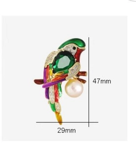 Detail view of parrot brooch dimensions showing 47mm height and enamel craft details