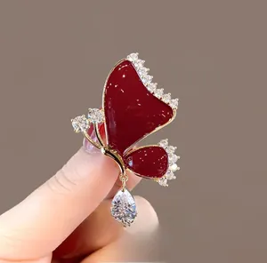 Macro shot of elegant red butterfly hair clasp with sparkling zircons and a teardrop gem