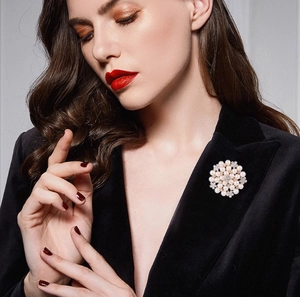 Elegant floral pearl brooch with sparkling crystals on black velvet blazer lapel