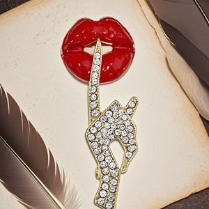 Elegant red lips enamel brooch with gold rhinestone finger on retro background