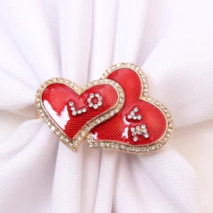 Macro detail of red enamel heart napkin ring with sparkling LOVE rhinestone lettering