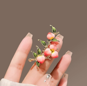 Elegant peach branch brooch with pink gradient fruits and green enamel leaves