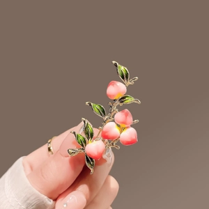 Exquisite peach branch brooch with pink enamel fruit and green leaves on gold branch