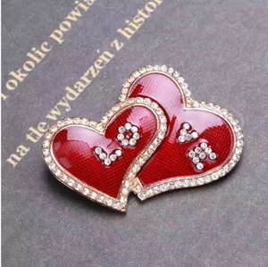 Elegant red enamel heart brooch with LOVE rhinestones on vintage book background
