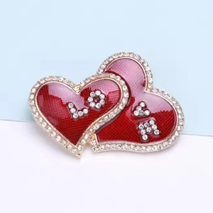 Elegant heart-shaped brooch with LOVE lettering and crystals in red and pink enamel