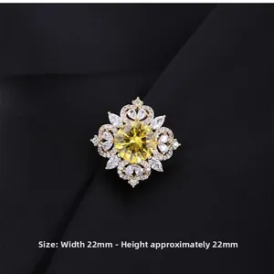 Detailed view of yellow crystal flower brooch with white zircon stones measuring 22mm x 22mm