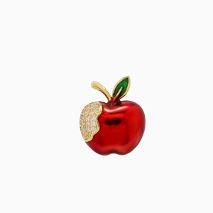 Exquisite red apple brooch with green leaf and sparkling crystals on white background