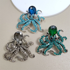 Detail of octopus brooches with pear-cut gemstones and sparkling crystal tentacles
