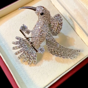 Elegant hummingbird brooch with white zircon pavé setting and black gemstone eye for suits