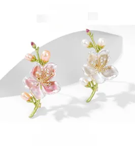 Dettaglio delle spille a fiore di magnolia con perle, petali smaltati e piccoli diamanti