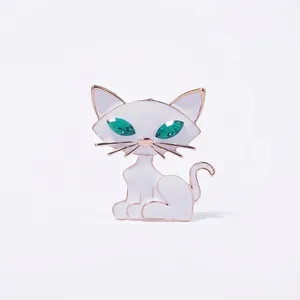 Spilla gatto in smalto bianco con occhi in cristallo verde e finitura in metallo dorato