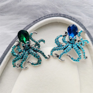 Macro shot of octopus brooches with teardrop gemstones and crystal inlaid tentacles