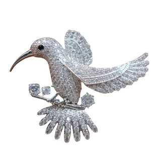Exquisite silver-tone hummingbird brooch with sparkling zircons and a black gem eye