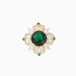 Luxury emerald crystal brooch with gold-plated floral petals on a white background
