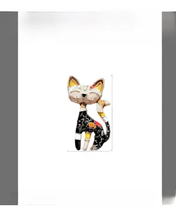 Detailed macro view of black and white cartoon cat brooch with enamel finish
