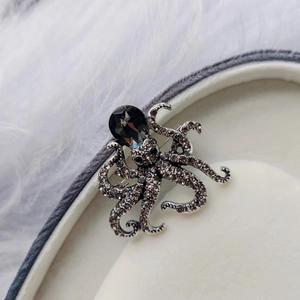 Octopus animal brooch with silver metal finish and sparkling grey rhinestones
