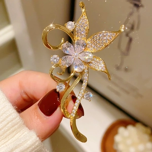 Close-up of a vintage floral brooch with sparkling crystals and gold-plated details