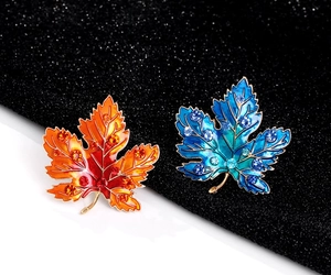 Detail view of maple leaf brooches with gradient enamel and sparkling rhinestones