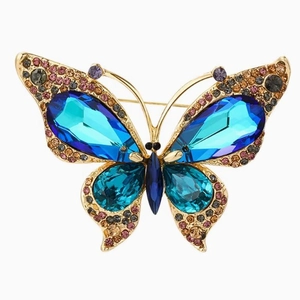 Elegant vintage butterfly brooch with blue crystals and rhinestones on a golden base