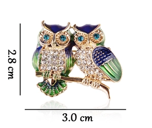 Detailed size view of an owl brooch in gold alloy with blue enamel and rhinestones
