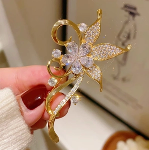 Elegant vintage gold bauhinia flower brooch with full pavé crystals for luxury blazers