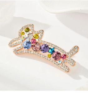 Détail de la broche chiot en cristal avec gemmes colorées et base en or rose élégante