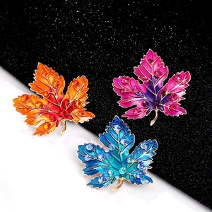 Exquisite enamel maple leaf brooch set with vibrant gradient colors and sparkling crystals
