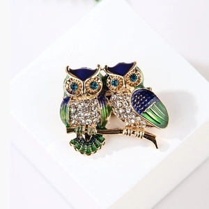 Elegant gold-tone owl branch brooch with blue enamel inlay and sparkling rhinestones