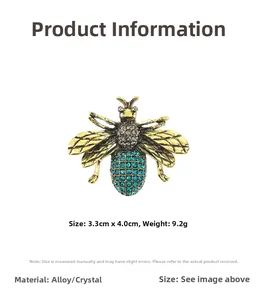 Detailed macro view of bee brooch showing 3.3cm size dimensions and green rhinestone belly