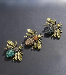 Detailed close-up of three vintage bee brooches with colorful rhinestones on alloy wings