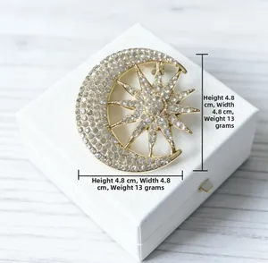 Detail view of gold moon and star brooch with rhinestones showing 4.8x4.8cm dimensions