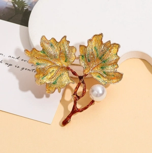 Vintage enamel maple leaf brooch with pearl accent in gold-plated autumn leaf style