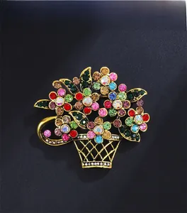 Close-up of vintage flower basket brooch with colorful rhinestones and gold plating