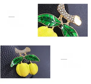 Macro d'une broche fruit avec émail jaune et feuilles serties de strass brillants
