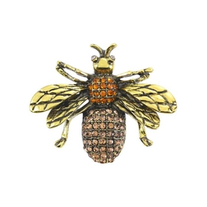 Vintage gold bee brooch with amber rhinestones and bionic wing textures on white background
