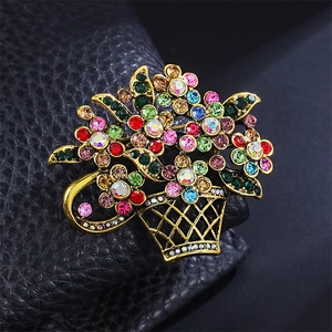 Close-up of vintage flower basket brooch with colorful rhinestones and gold alloy frame
