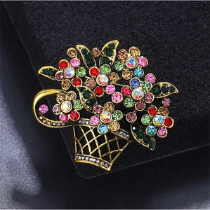 Macro shot of colorful rhinestones on a vintage flower basket brooch with gold finish