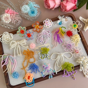 Ciondoli colorati per scarpe a fiori e accessori in perle su vassoio in legno