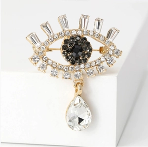 Luxury Evil Eye Brooch in gold finish with sparkling rhinestones and pear-shaped crystal