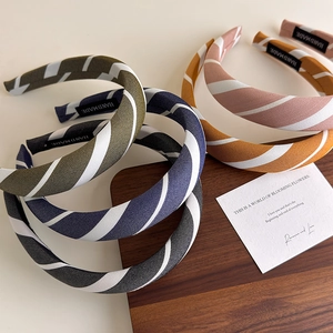 Striped fabric headband with sponge padding in various colors for stylish hair styling